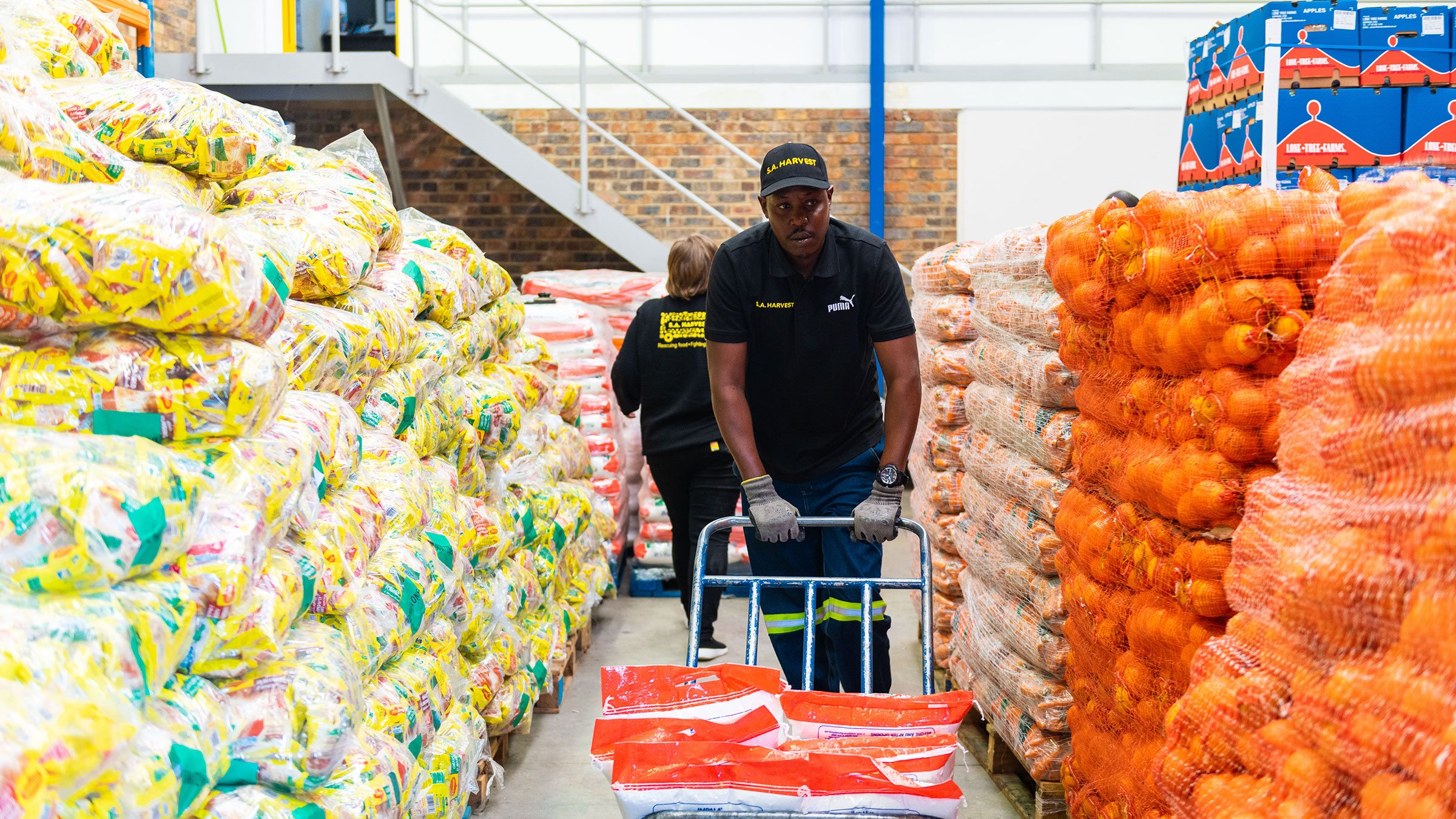 A man pushes a trolley in a food warehouse
